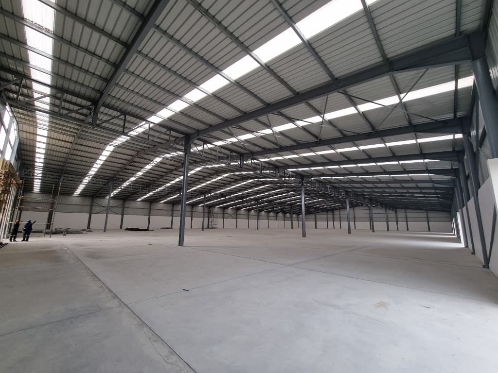 Spacious Union Marine warehouse interior with steel roof trusses and an open concrete floor